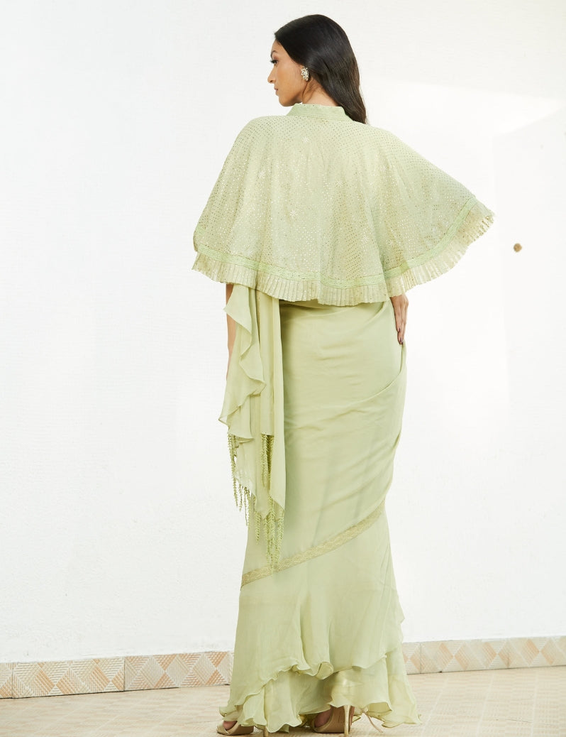 The mint green colored ruffle saree with hand embroidery